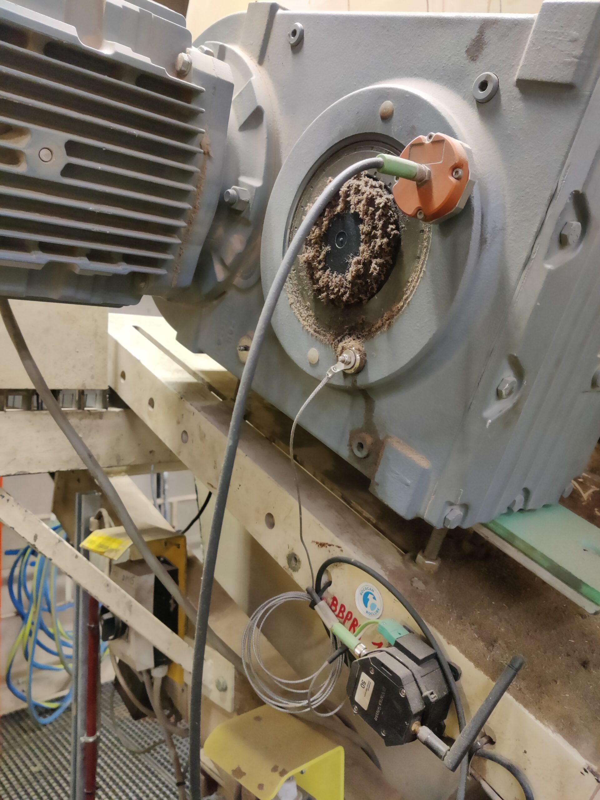 A VersaSense Intelligent Vibration Sensor installed on a machine at Unilin Panels.